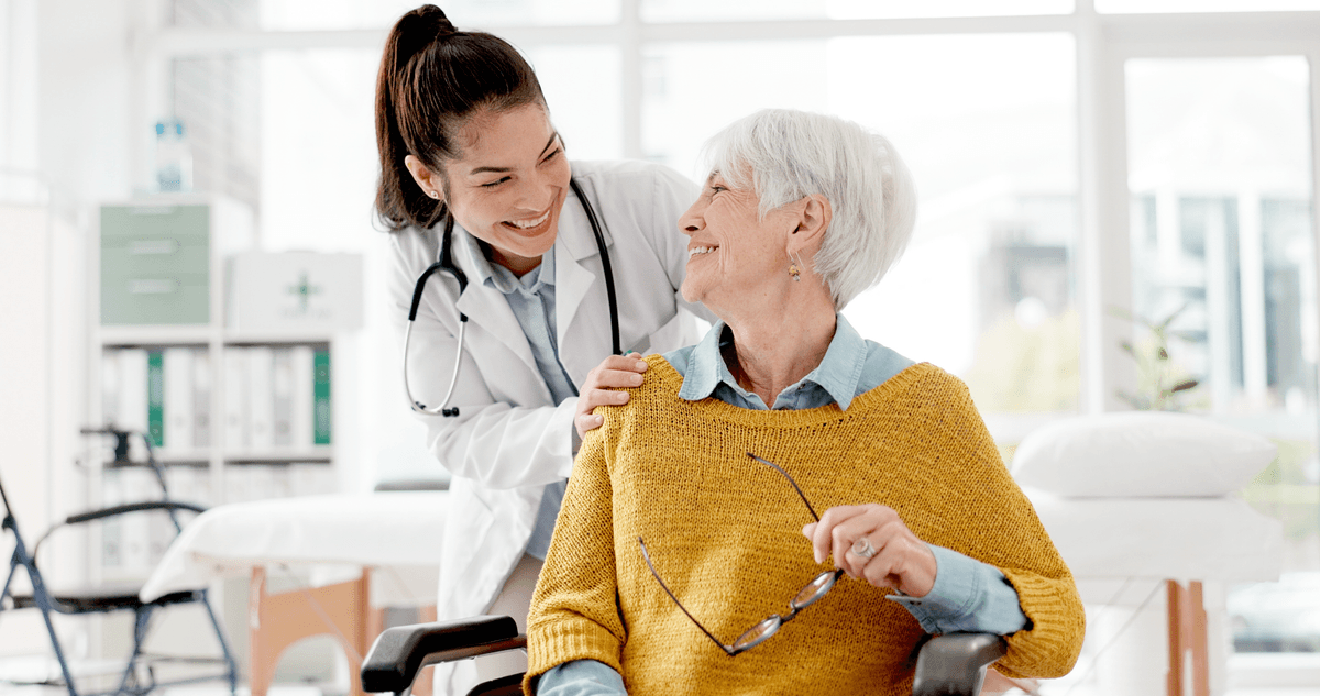 Doctor smiling with elderly patient in a clinical setting