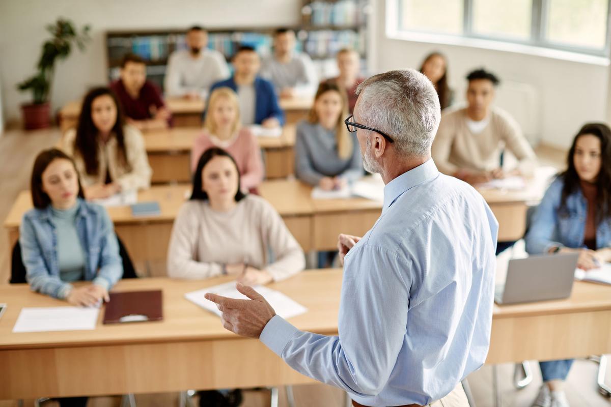 Professor lecturing to university students in a classroom